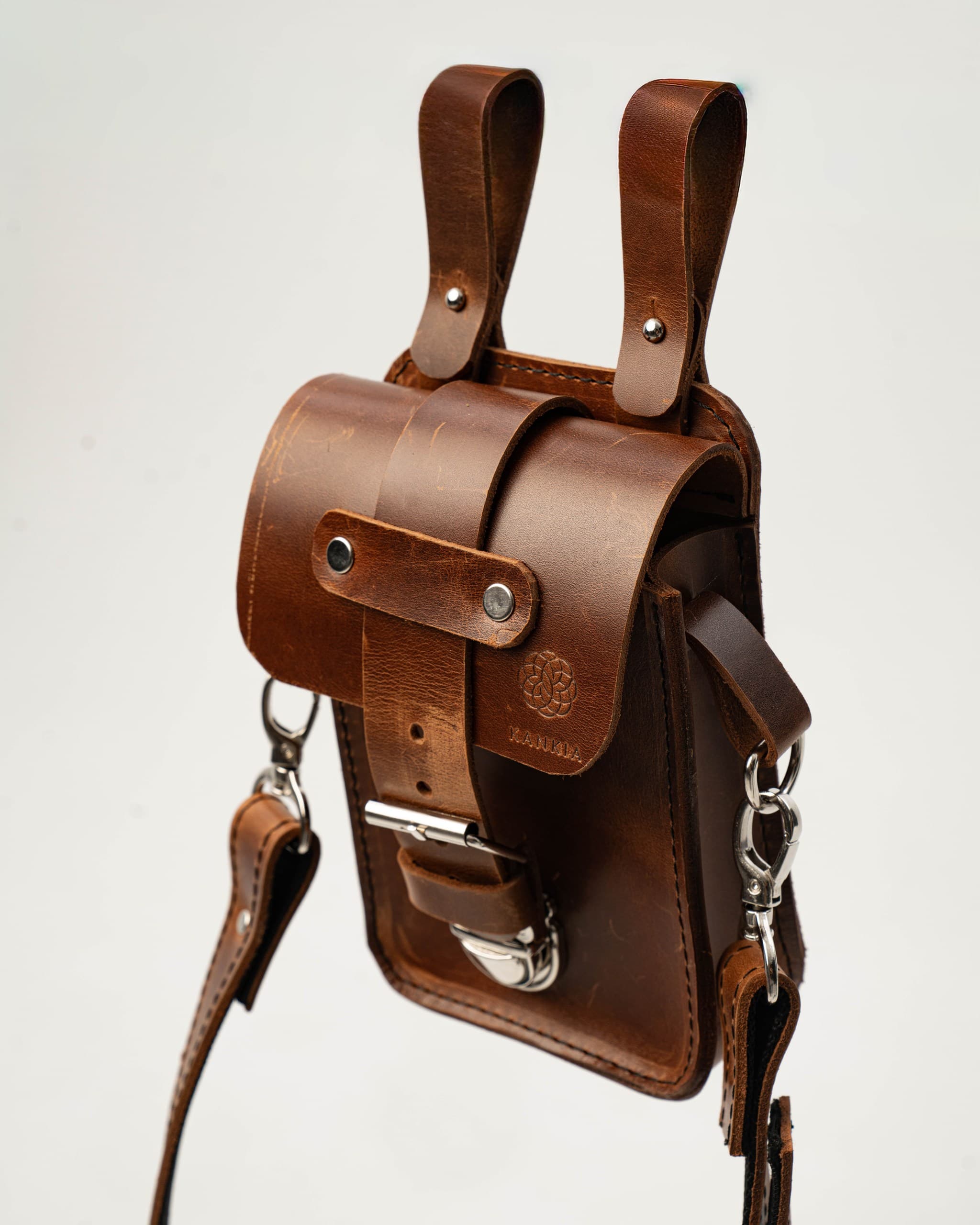 Kankia brown leather holster satchel bag with double loop handle and Kankia embossed logo, white background