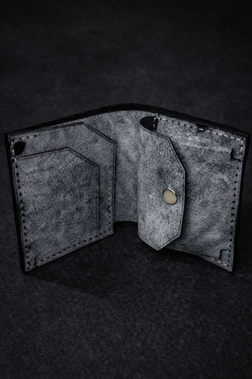Kankia grey crackle-leather bifold wallet open, showing card slots and coin pocket interior